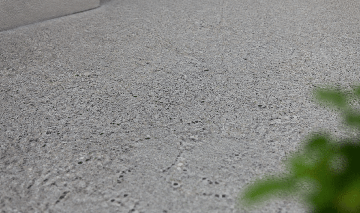 Surface de beton desactive grise avec motif granuleux visible